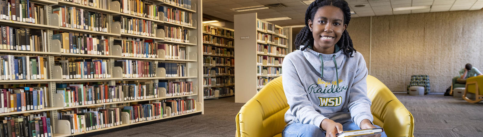 photo of a student sitting in the library