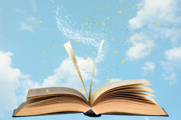 Open book with a background of clouds in the sky