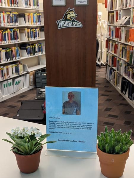 In Memoriam sign on for Edward Trentman on the circulation desk at the Dunbar Library