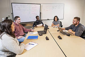 Students meeting in a group study room in the Dunbar Library