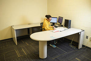 Student studying in 328A individual study room in the Dunbar Library