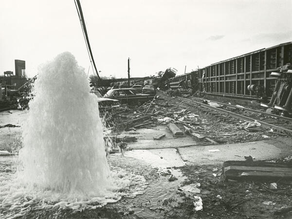 Ruptured fire hydrant at West 2nd Street in Xenia. Overturned railroad cars in the background.