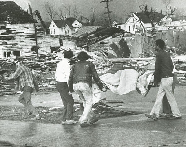 People carrying a gurney amid the aftermath of the Xenia tornado. 