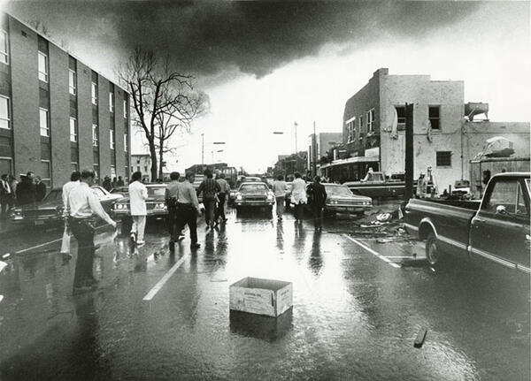 People and cards on the street of tornado ravaged Xenia.