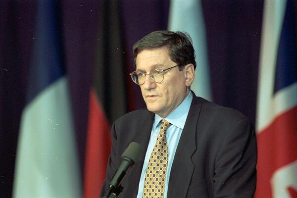 Richard Holbrooke standing at podium.