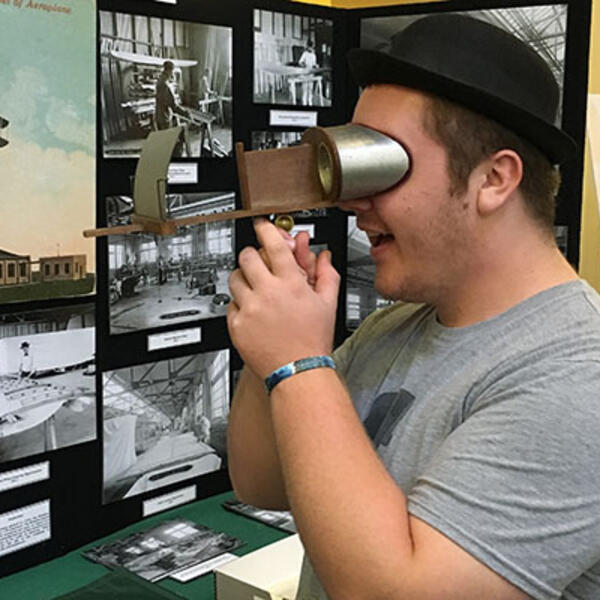 Student interacting with Wright Brothers exhibit