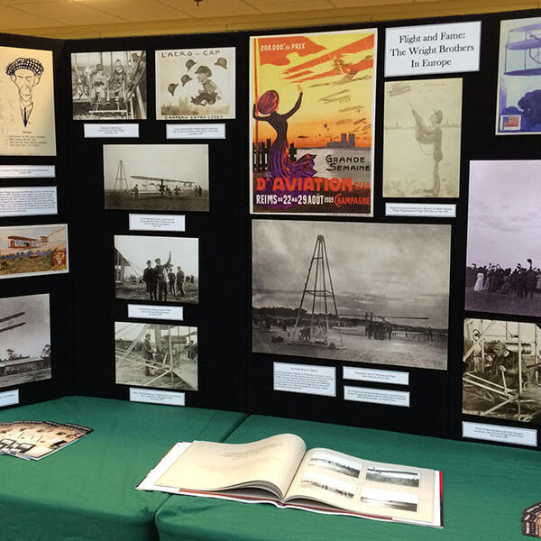 Wright Brothers Day display table with images related to the Wright Brothers and the history of flight