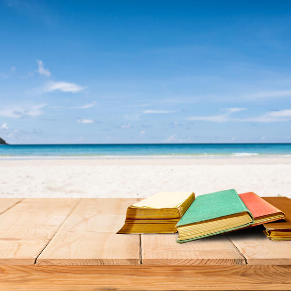 Image of books on bench at beach
