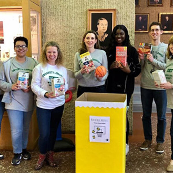 Photo of library staff members and food pantry donation box