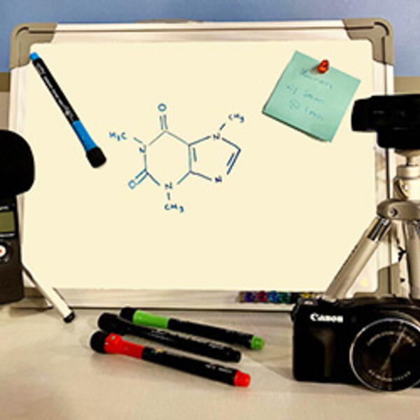 Photo of mini-whiteboard with tripods, cameras, and markers