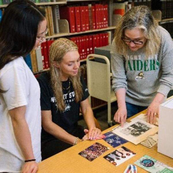image of Toni Vanden Bos working with students in the Archives
