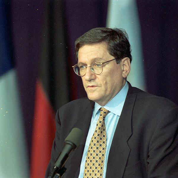 Richard Holbrooke standing at podium.