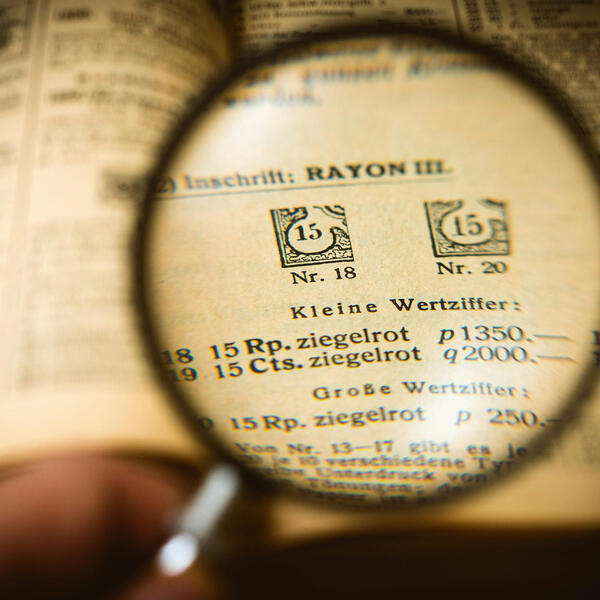 image of book with magnifying glass