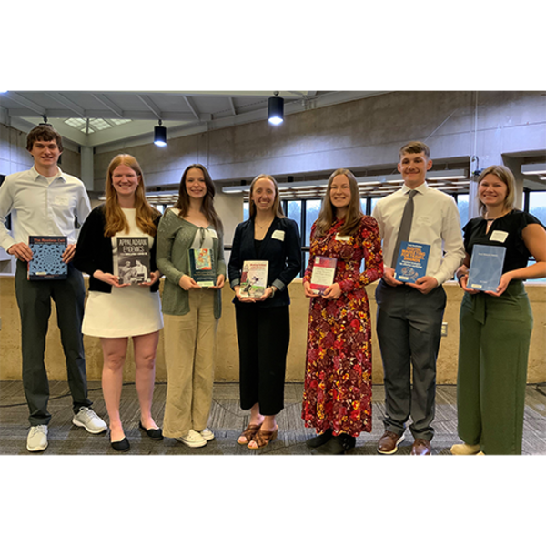 Image of 2026 Top Scholar students holding their selected library books