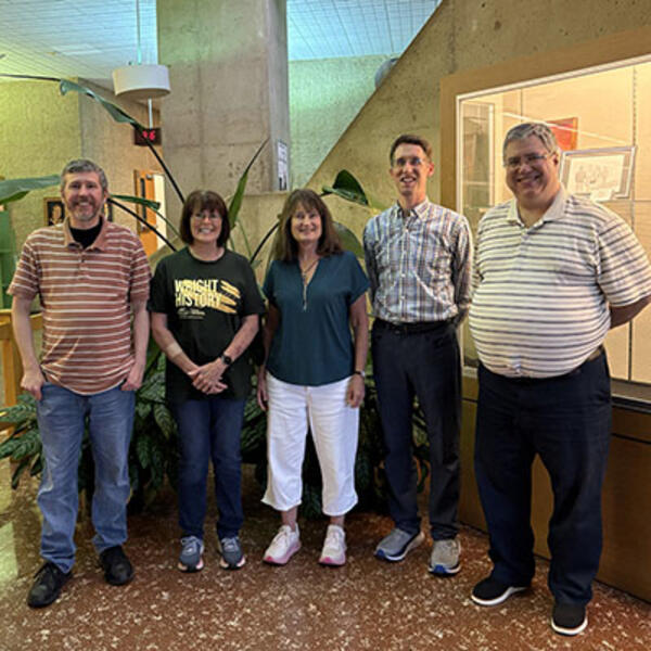 Photo of 2026 Service Year Award recipients standing in the Dunbar Library lobby