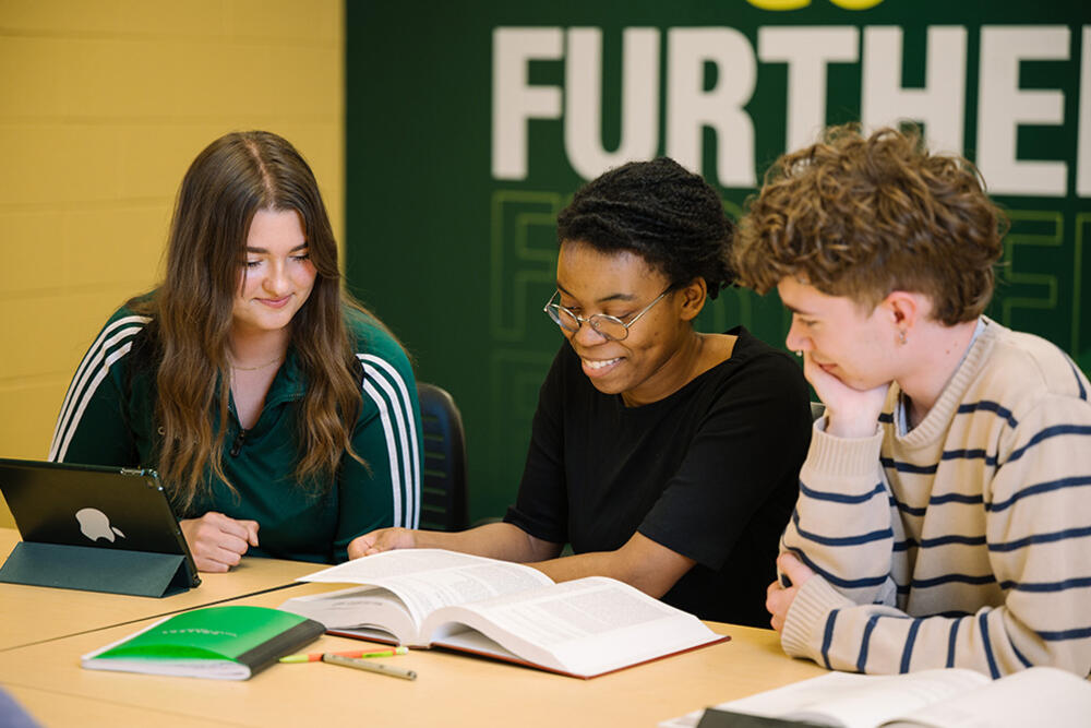 Students using library materials in a University Libraries group study room