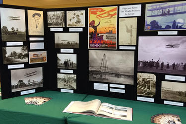 Wright Brothers Day display table with images related to the Wright Brothers and the history of flight