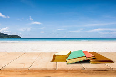 Image of books on bench at beach