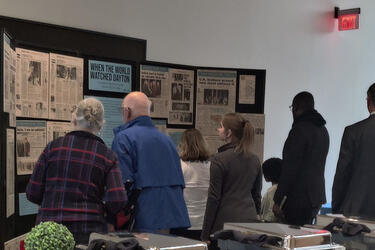 Image of people viewing the When the World Watched Dayton exhibit