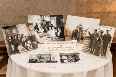 A group of historical images on display on a tabletop.