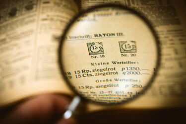 image of book with magnifying glass